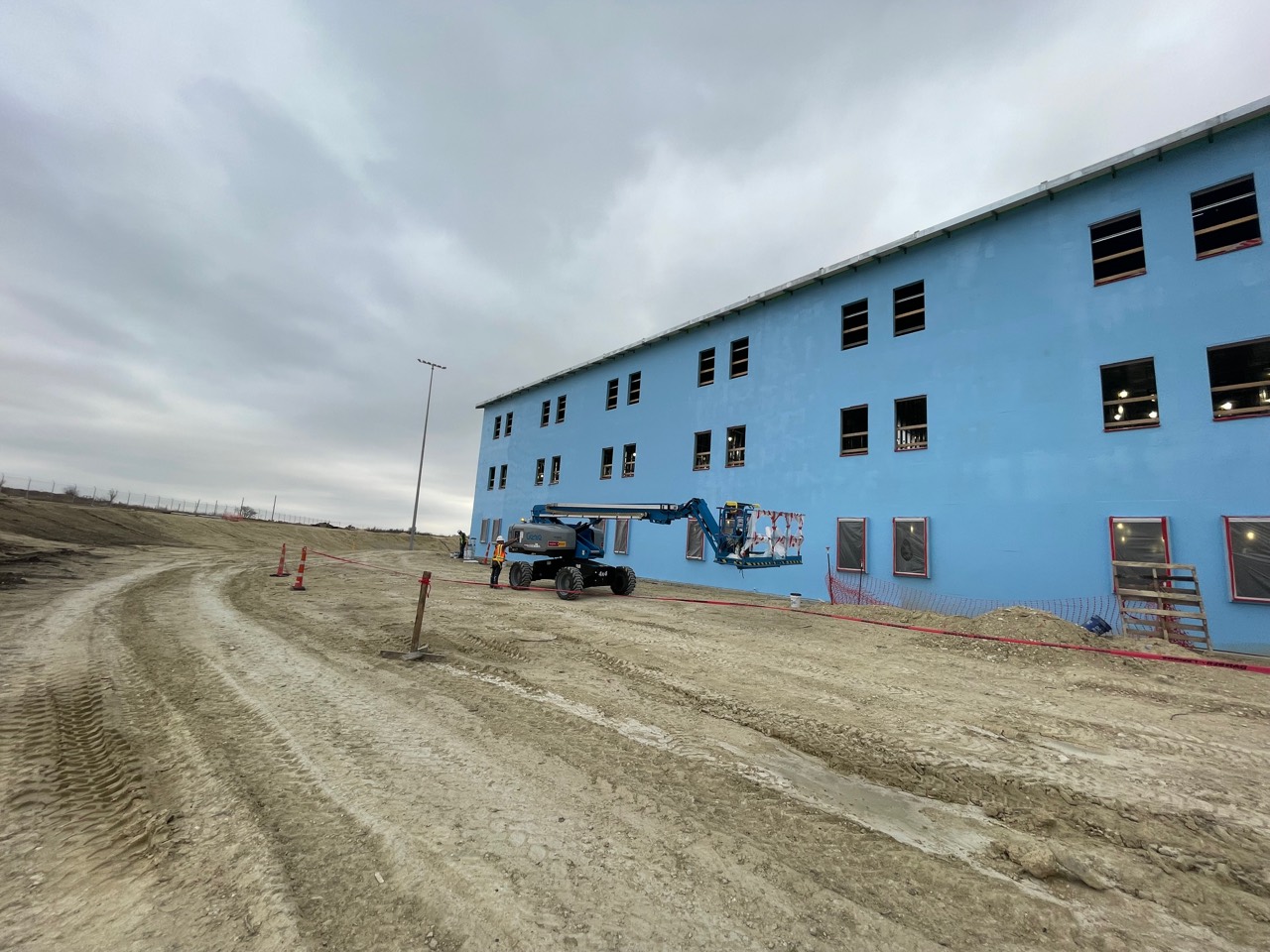Large commercial building during exterior waterproofing work